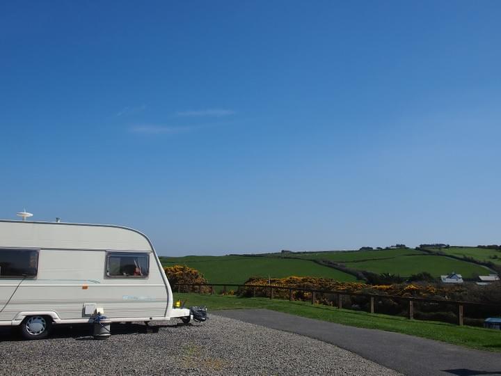 Touring caravan on a gravel pitch at North Morte Farm