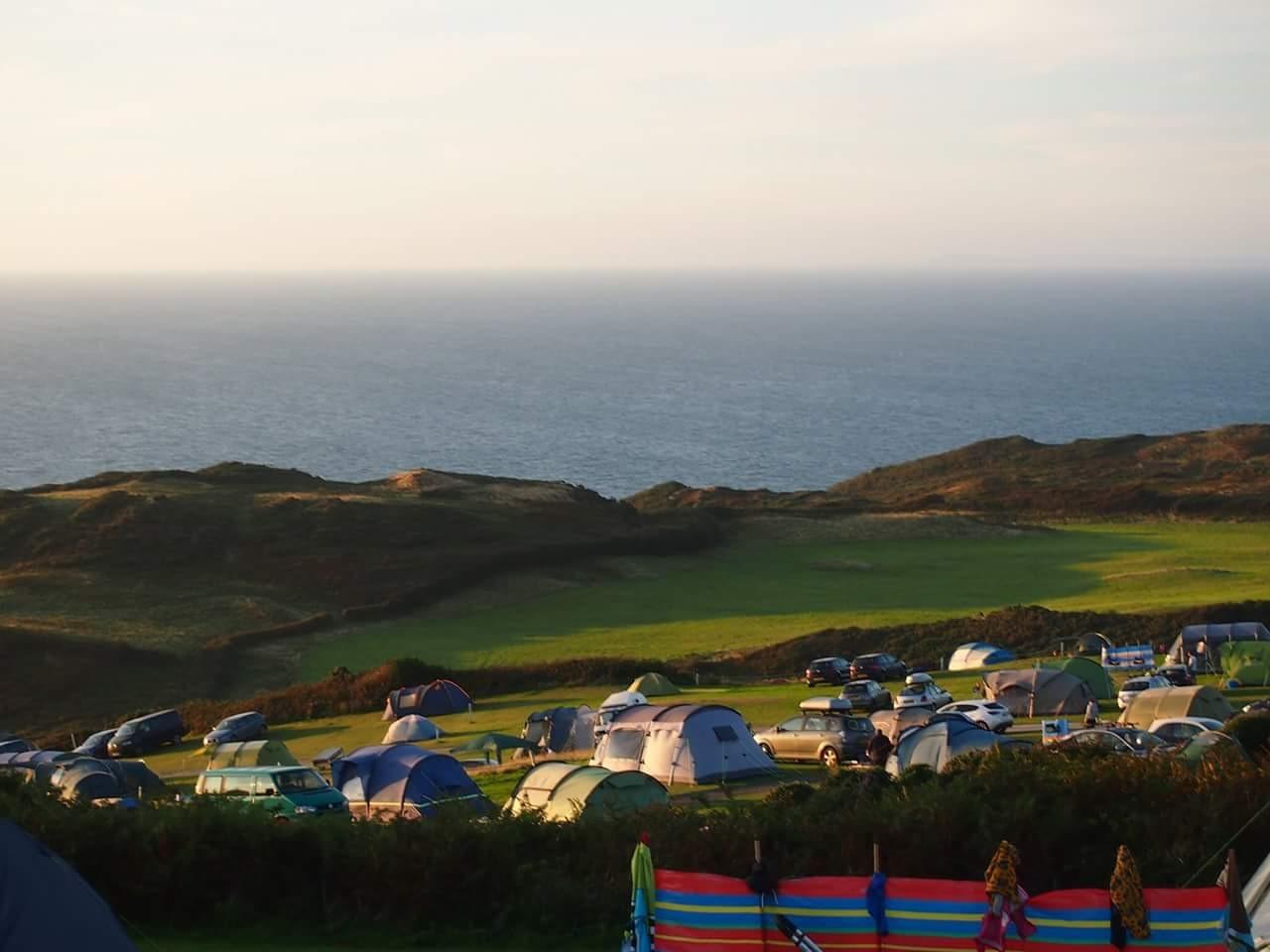 Evening light over the camping fields and the North Devon coast